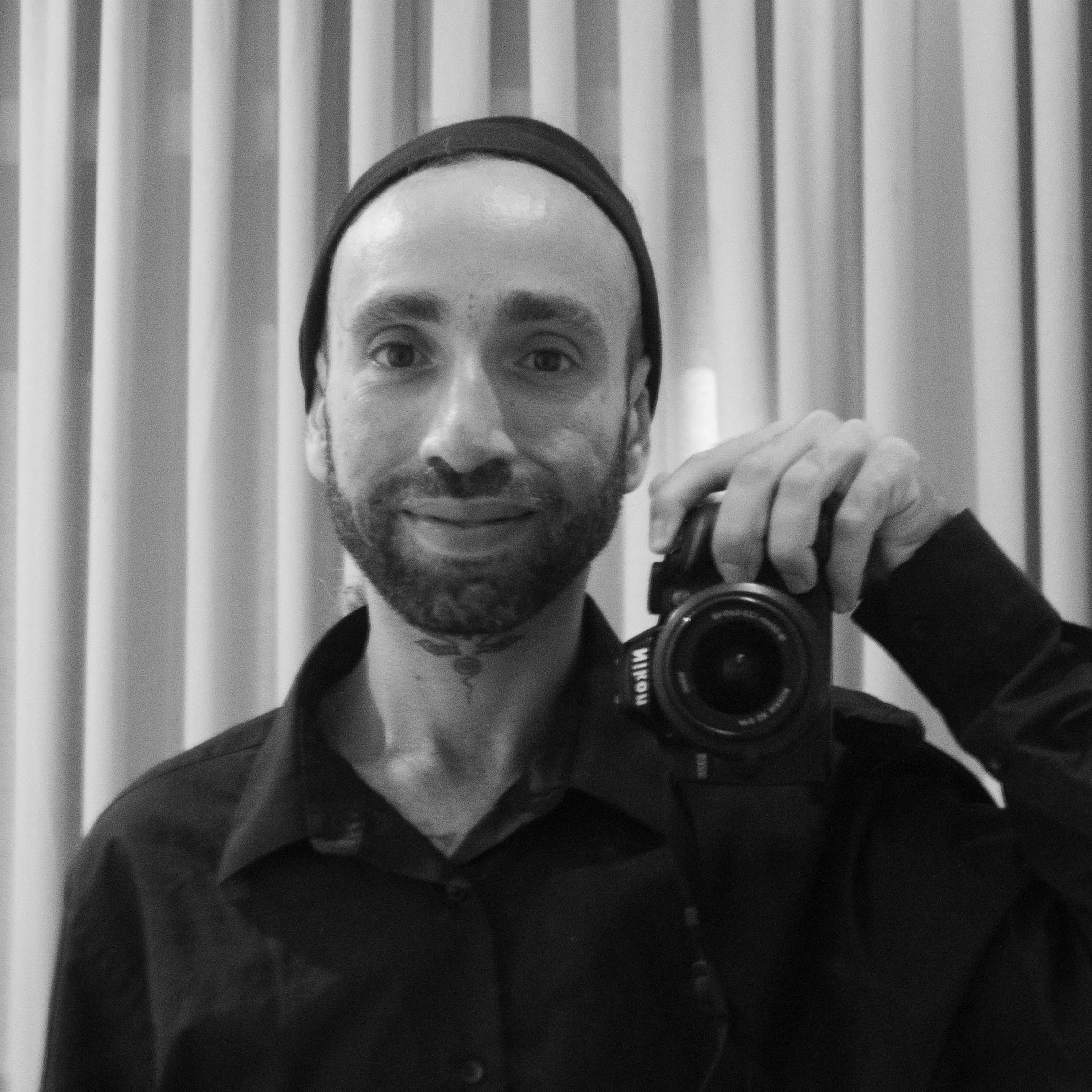black and white selfie of myself holding a camera